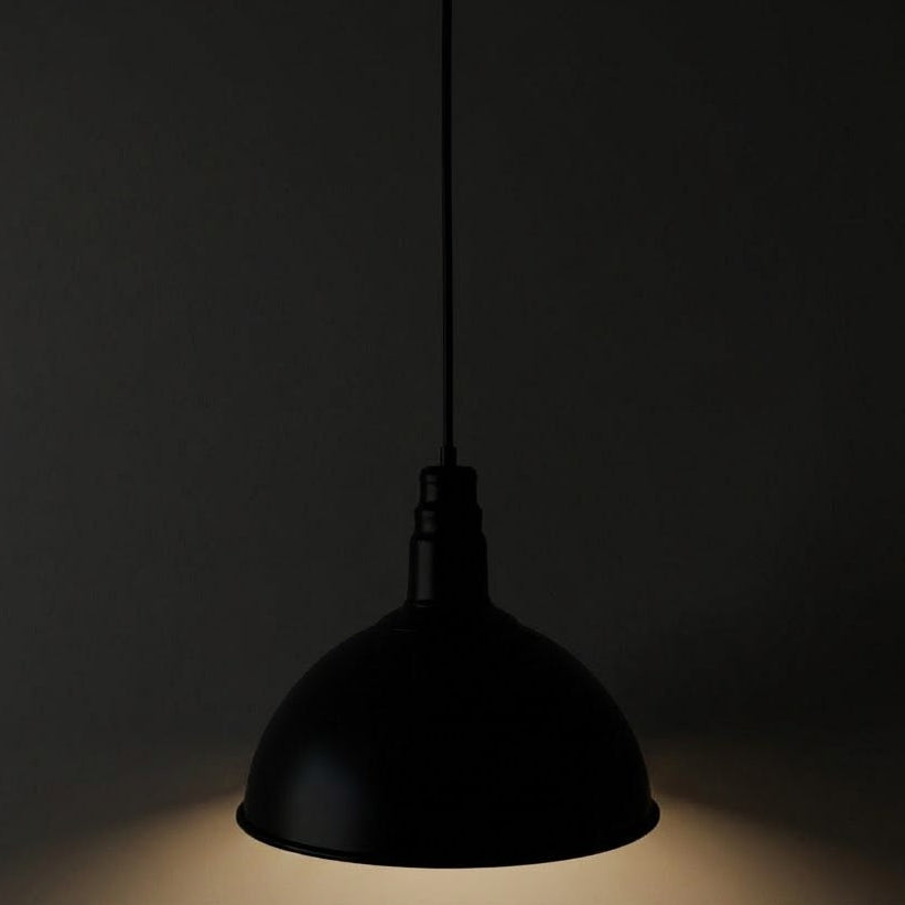 Black pendant light against a dark background