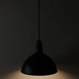 Black pendant light against a dark background
