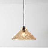 Pendant light with ribbed glass shade on a white background