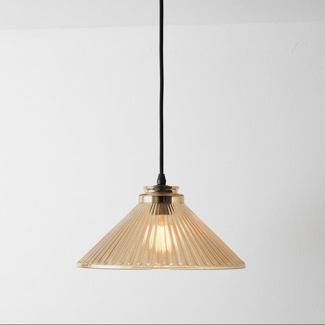 Pendant light with ribbed glass shade on a white background