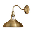 Brass wall-mounted light fixture on a white background