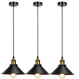 Three black pendant lights with gold accents on a white background