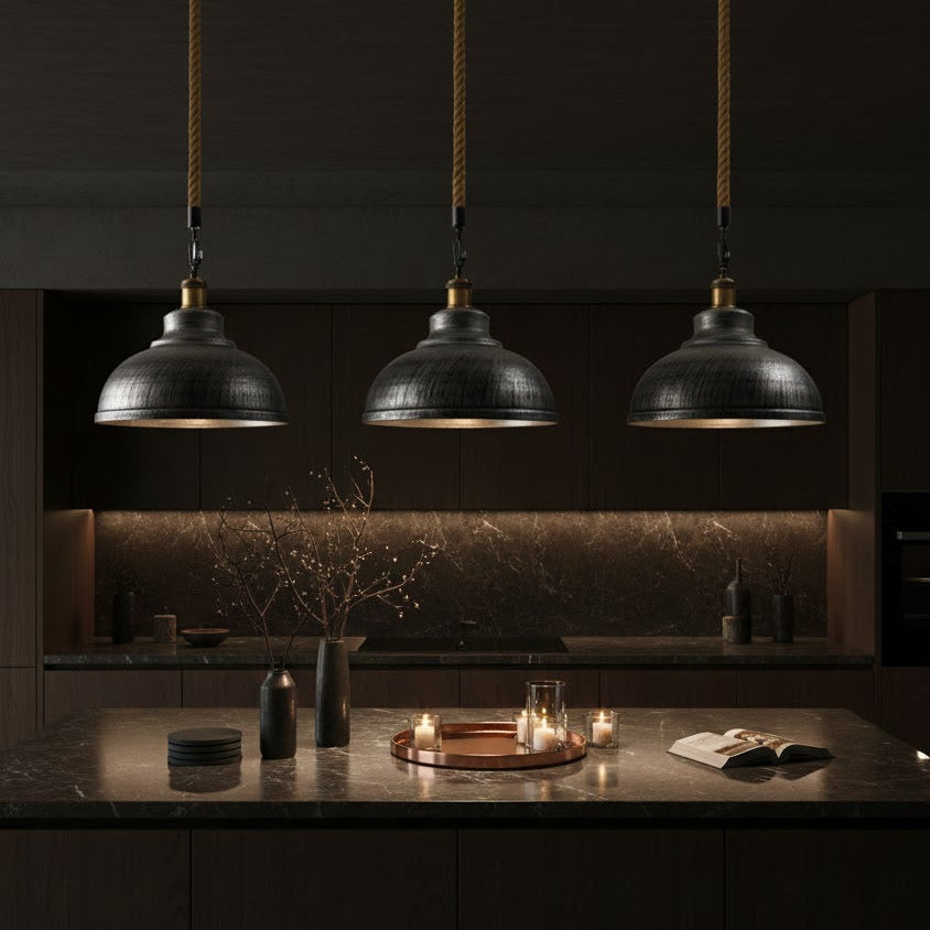 Three silver pendant lights hanging above a kitchen counter