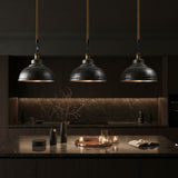 Three silver pendant lights hanging above a kitchen counter