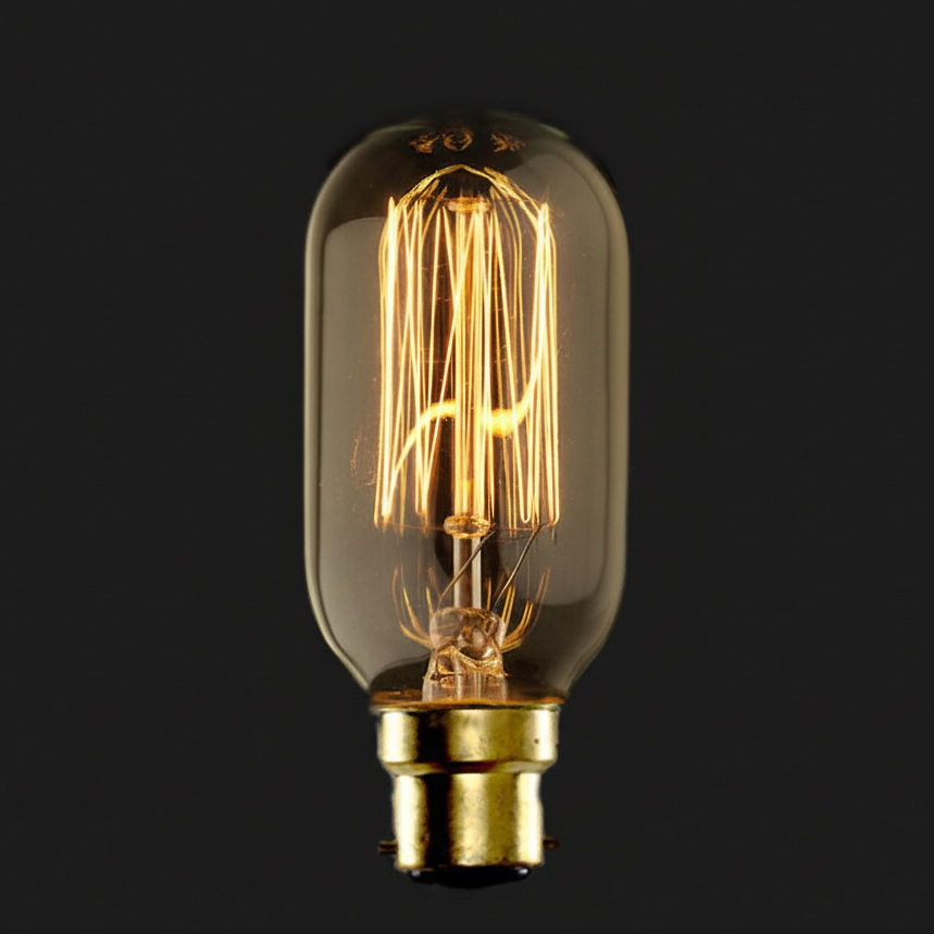 Vintage-style light bulb with clear glass and gold base on a black background