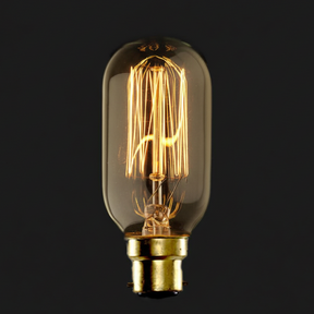 Vintage-style light bulb with clear glass and gold base on a black background
