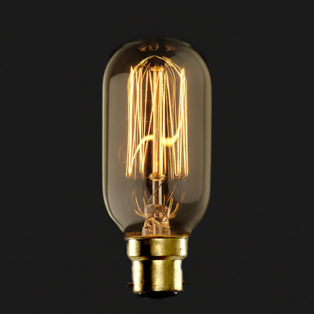 Vintage-style light bulb with clear glass and gold base on a black background