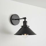 Black wall-mounted lamp with a white background