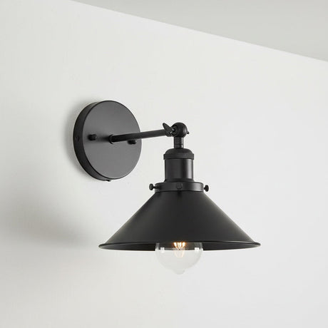 Black wall-mounted lamp with a white background